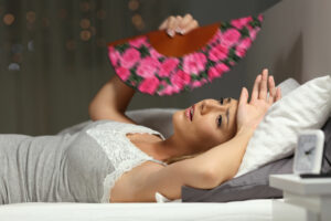 Overwhelmed Woman Fanning Herself in Intense Summer Heat